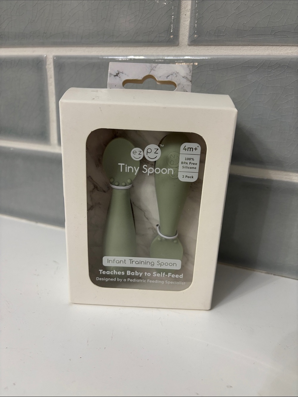 ezpz Tiny Spoon is a 100% silicone infant training spoon